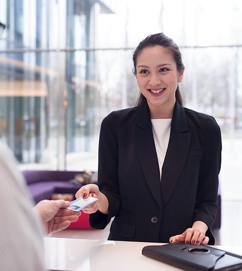 women gives a badge to another person